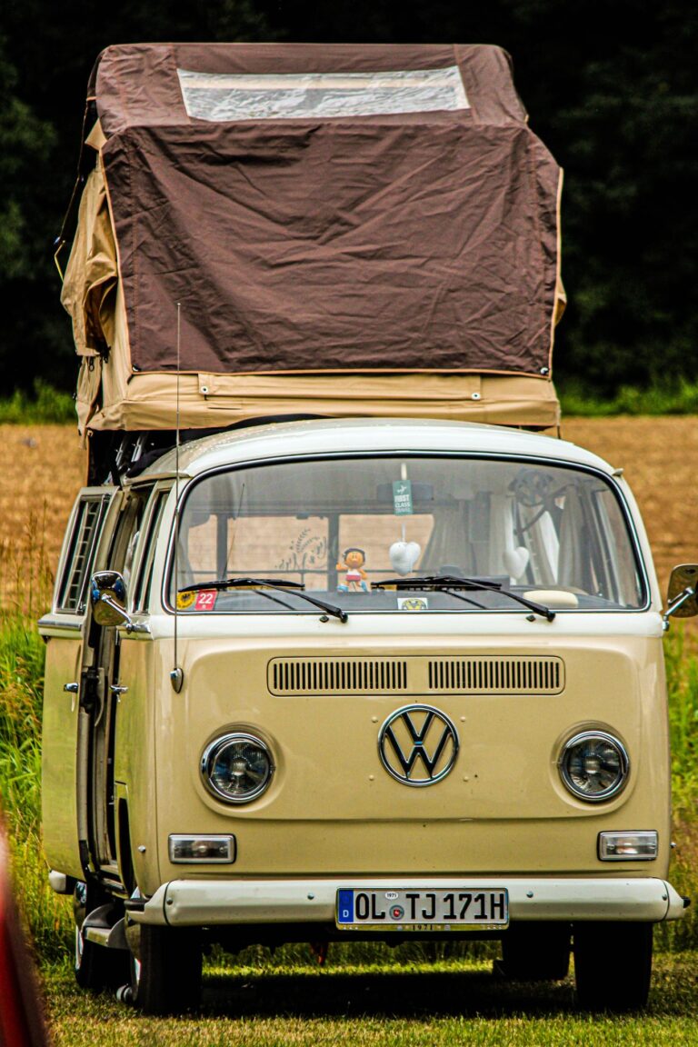Classic Volkswagen van with pop-up tent roof parked outdoors near Oldenburg.